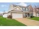 Charming two-story home with brick and siding exterior, well-manicured lawn and attached two-car garage at 1464 Hession Dr, Brownsburg, IN 46112
