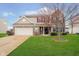 Charming two-story home with brick and siding exterior, well-manicured lawn and attached two-car garage at 1464 Hession Dr, Brownsburg, IN 46112