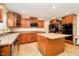 Well-equipped kitchen with granite countertops, an island, stainless steel appliances, and custom cabinetry at 1464 Hession Dr, Brownsburg, IN 46112