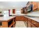 Well-lit kitchen featuring granite countertops, matching cabinetry, an island and stainless steel appliances at 1464 Hession Dr, Brownsburg, IN 46112
