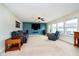 Spacious living room has large windows, a ceiling fan, and a mounted television at 1464 Hession Dr, Brownsburg, IN 46112