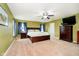 Spacious main bedroom showcasing a ceiling fan, dressers, walk-in closet, and ensuite bathroom at 1464 Hession Dr, Brownsburg, IN 46112