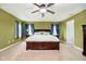 The main bedroom is expansive with large windows, ceiling fan and coordinating furniture at 1464 Hession Dr, Brownsburg, IN 46112