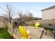 Backyard patio area with a table, yellow chairs, and a wood fence at 14974 Dry Creek Rd, Noblesville, IN 46060