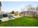 Well-kept backyard featuring a wooden deck, green lawn, and a charming shed for extra storage at 14974 Dry Creek Rd, Noblesville, IN 46060