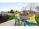Backyard patio area with an outdoor kitchen, shed, and unique yellow chairs at 14974 Dry Creek Rd, Noblesville, IN 46060