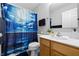 Bathroom featuring a unique ocean-themed shower curtain, wooden vanity, and modern fixtures at 14974 Dry Creek Rd, Noblesville, IN 46060