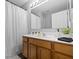 Bathroom featuring a wide mirror, wooden cabinets, and shower with white curtain at 14974 Dry Creek Rd, Noblesville, IN 46060