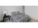 Cozy bedroom featuring black and white patterned bedding and a view of an open closet door at 14974 Dry Creek Rd, Noblesville, IN 46060