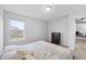 Bright bedroom featuring a patterned bed, dark wood dresser, and a view out the window at 14974 Dry Creek Rd, Noblesville, IN 46060