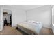 A bright bedroom with a patterned bed, closet, and a view out of the window at 14974 Dry Creek Rd, Noblesville, IN 46060