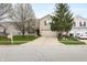 Charming home featuring a two-car garage, lovely landscaping, and beautiful flowering trees in a well-maintained front yard at 14974 Dry Creek Rd, Noblesville, IN 46060