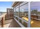 Wooden balcony with large windows, offering city views and letting in ample light into the home at 1529 Alabama N St # H, Indianapolis, IN 46202