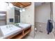 Bathroom featuring double sink, granite countertops, tile floor, modern finishes, and a glass enclosed shower at 1529 Alabama N St # H, Indianapolis, IN 46202