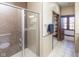 Bathroom featuring a glass shower enclosure, closet, towel rack and tiled floors, providing a spa-like experience at 1529 Alabama N St # H, Indianapolis, IN 46202