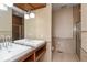 Modern bathroom featuring double sinks, granite countertops, and walk-in shower at 1529 Alabama N St # H, Indianapolis, IN 46202