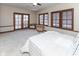 Sunlit bedroom featuring a ceiling fan, natural light, and access to an outdoor balcony seating area at 1529 Alabama N St # H, Indianapolis, IN 46202