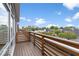 Spacious deck with wooden railings, offering views of the neighborhood and sky, perfect for relaxation and outdoor enjoyment at 1529 Alabama N St # H, Indianapolis, IN 46202