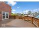 View of the beautiful wood deck with brick accents and wooden railing, perfect for outdoor entertaining and relaxation at 1529 Alabama N St # H, Indianapolis, IN 46202