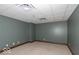 Spacious room with neutral carpet, wood trim, and ample lighting, presenting a versatile space for various uses and customization at 1529 Alabama N St # H, Indianapolis, IN 46202