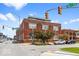 Street view of a three-story red brick building with a modern addition on top under a bright blue sky at 1529 Alabama N St # H, Indianapolis, IN 46202