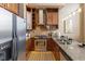 Gourmet kitchen featuring stainless steel appliances, granite countertops, and custom wood cabinetry at 1529 Alabama N St # H, Indianapolis, IN 46202