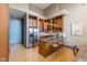Well-lit kitchen with stainless steel appliances, granite counters, breakfast bar, and custom cabinetry at 1529 Alabama N St # H, Indianapolis, IN 46202