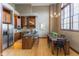 Open kitchen featuring stainless steel appliances, wooden cabinets, and granite countertops with breakfast bar at 1529 Alabama N St # H, Indianapolis, IN 46202