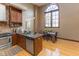 Bright kitchen and dining area with hardwood floors, granite countertops, and stainless steel appliances at 1529 Alabama N St # H, Indianapolis, IN 46202