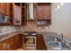 Well-equipped kitchen featuring stainless steel appliances, granite countertops, and tiled backsplash at 1529 Alabama N St # H, Indianapolis, IN 46202
