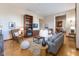 Spacious living room with hardwood floors, fireplace, built-ins, and open layout into the kitchen at 1529 Alabama N St # H, Indianapolis, IN 46202