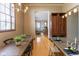 Open concept living area featuring a kitchen island, dining area, and living room with hardwood floors at 1529 Alabama N St # H, Indianapolis, IN 46202
