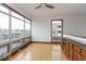 Bright living room with hardwood floors, large windows, and a built-in bar area, creating a perfect space for relaxation at 1529 Alabama N St # H, Indianapolis, IN 46202