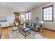 Open-concept living area featuring hardwood floors, neutral walls, and an abundance of natural light at 1529 Alabama N St # H, Indianapolis, IN 46202