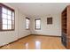 Spacious living room with hardwood floors and large windows at 1529 Alabama N St # H, Indianapolis, IN 46202