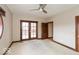 Serene bedroom boasting neutral tones, carpet flooring, and access to outdoor balcony at 1529 Alabama N St # H, Indianapolis, IN 46202