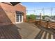 Spacious outdoor deck with string lights, brick wall and wooden floor, perfect for entertaining at 1529 Alabama N St # H, Indianapolis, IN 46202