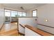 Bright staircase with hardwood floors and railing, offering views of the outdoors from the upper landing at 1529 Alabama N St # H, Indianapolis, IN 46202