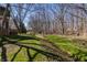 Large backyard with a creek, bridge and natural landscaping at 1591 Preston Trl, Carmel, IN 46032