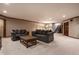 Finished basement with plush carpeting, comfortable seating, and plenty of open space for activities at 1591 Preston Trl, Carmel, IN 46032