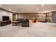 Large basement featuring cozy seating, a large screen television, and space for various activities and play areas at 1591 Preston Trl, Carmel, IN 46032