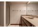 Bathroom featuring a walk-in shower, single sink, and patterned wallpaper at 1591 Preston Trl, Carmel, IN 46032