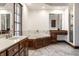 Bright bathroom with a large tub, double sinks, vanity, and tile floors at 1591 Preston Trl, Carmel, IN 46032