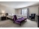 Comfortable bedroom with carpeted floors, bed, sitting area, and a large window at 1591 Preston Trl, Carmel, IN 46032