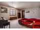 Spacious bedroom with a playful race car bed, piano, and ample room for activities and relaxation at 1591 Preston Trl, Carmel, IN 46032