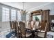 Elegant dining room with hardwood floors, large windows, and a decorative chandelier at 1591 Preston Trl, Carmel, IN 46032