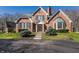 Beautiful red brick home featuring manicured lawn and stone pathway to front door at 1591 Preston Trl, Carmel, IN 46032