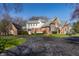 An estate home featuring red brick, multi-car driveway and mature trees at 1591 Preston Trl, Carmel, IN 46032
