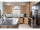Well-appointed kitchen features stainless appliances, island with seating and custom cabinetry at 1591 Preston Trl, Carmel, IN 46032
