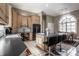 Gourmet kitchen features light wood cabinetry, tile backsplash, and a central island with seating at 1591 Preston Trl, Carmel, IN 46032
